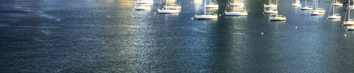 Sailboats on shimmering water near the coast of Massachusetts